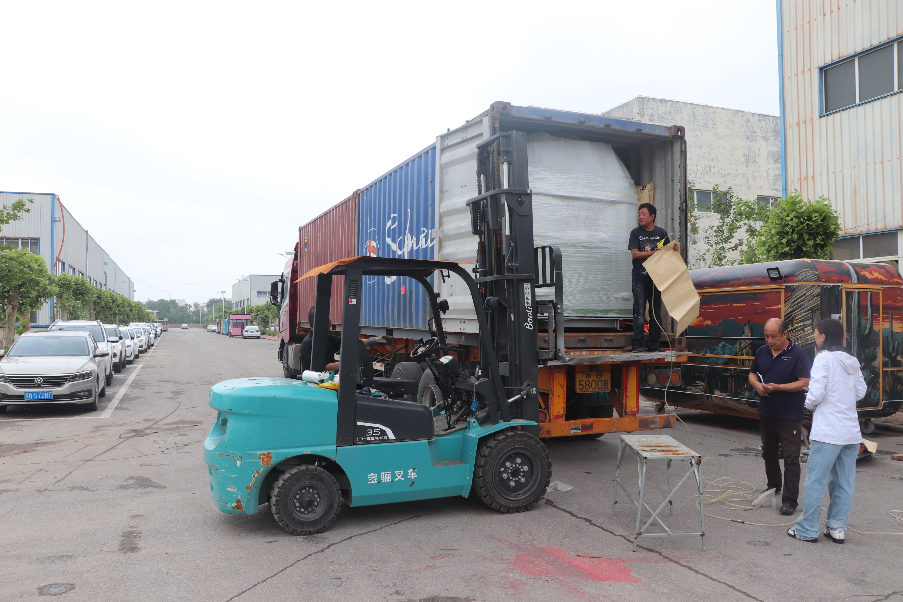 Completed food trailer being loaded into a shipping container